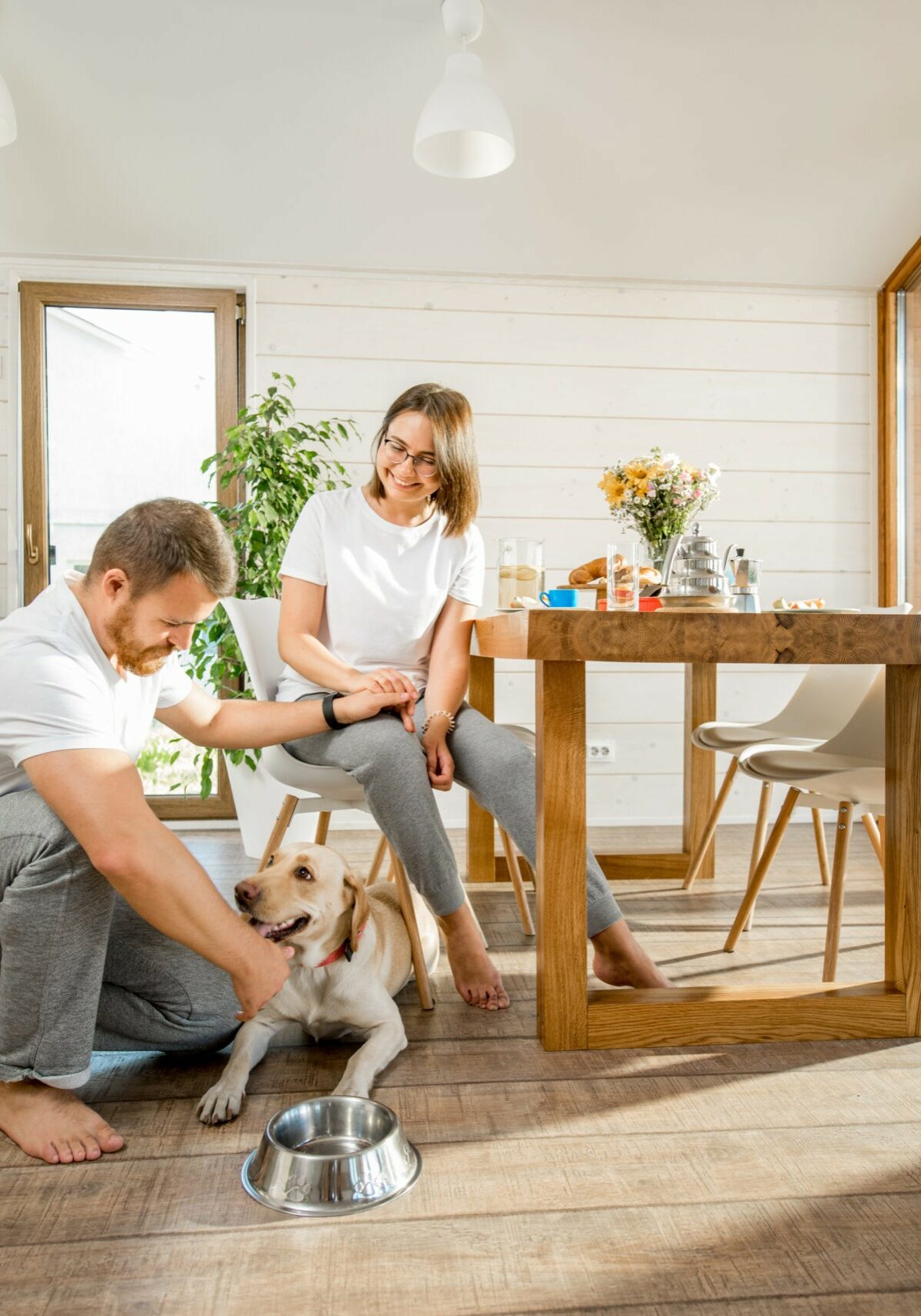 Young couple with dog at home | Sherm Arnold's Flooring